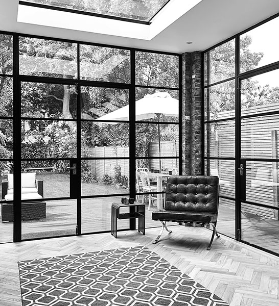 a lounge room surrounded by glass walls